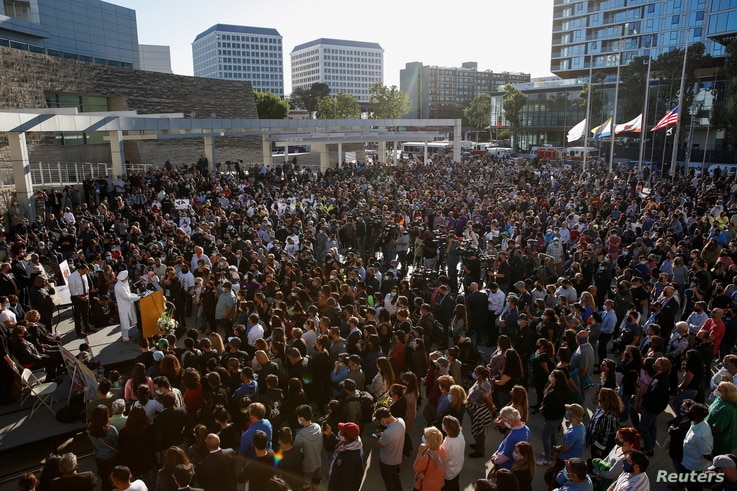 People attend a vigil for victims of a shooting at a rail yard run by the Santa Clara Valley Transportation Authority in San…