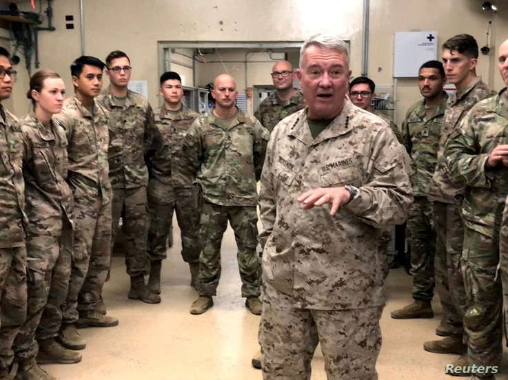 FILE PHOTO: Marine General Kenneth McKenzie, head of U.S. Central Command, speaks with U.S. troops while visiting Forward…