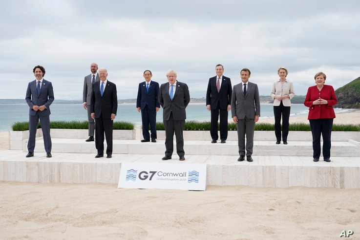 Leaders of the G7 pose for a group photo on overlooking the beach at the Carbis Bay Hotel in Carbis Bay, St. Ives, Cornwall,…