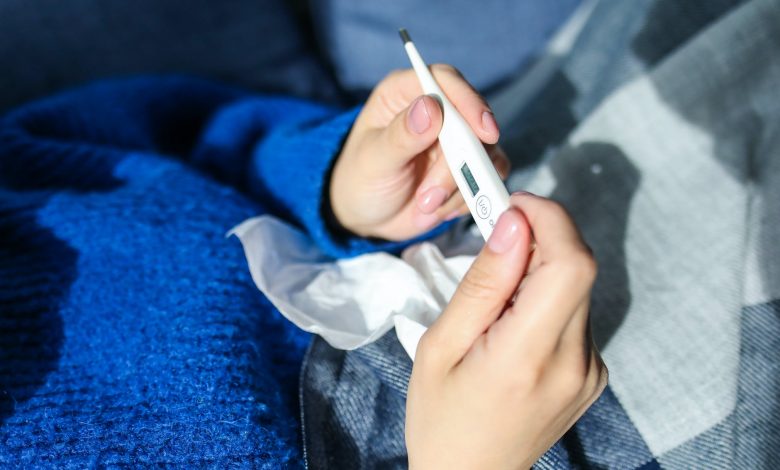 person holding thermometer