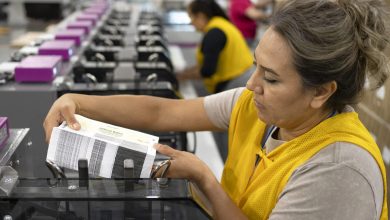 An employee adds a stack of mail-in ballots to a machine that automatically places the ballots in envelopes at Runbeck Election Services on Sept. 25, 2024 in Phoenix, Arizona. The company prints mail-in ballots for 30 states and Washington, D.C. (Rebecca Noble/Getty Images).