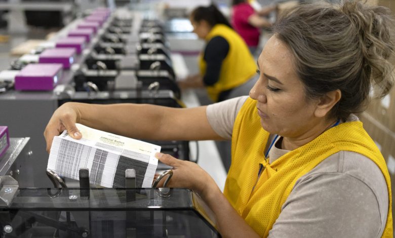 An employee adds a stack of mail-in ballots to a machine that automatically places the ballots in envelopes at Runbeck Election Services on Sept. 25, 2024 in Phoenix, Arizona. The company prints mail-in ballots for 30 states and Washington, D.C. (Rebecca Noble/Getty Images).