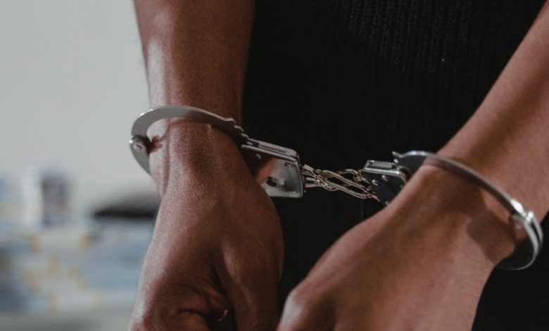 persons hands in handcuffs